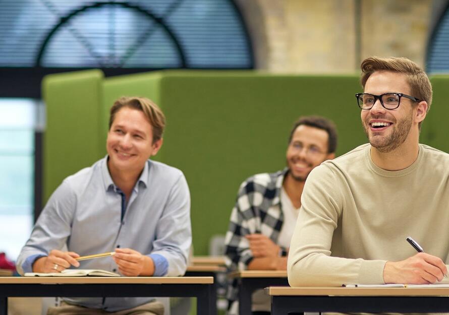 Group of multiracial business people sitting in the modern office and listening to coach or